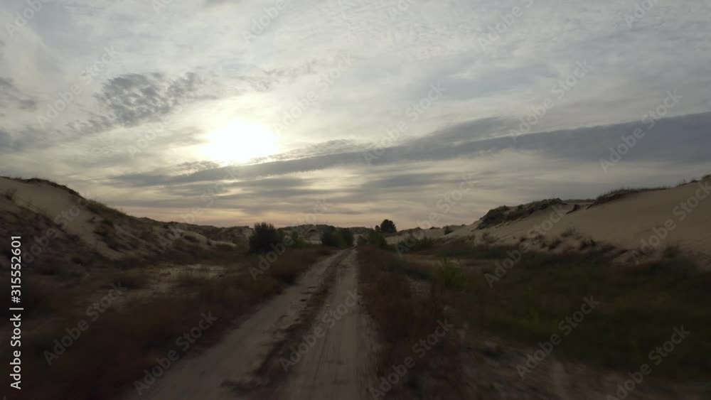 Stunning Aerial sunrise shot upon a desert offroad path Stunning Aerial sunrise shot upon a desert offroad path