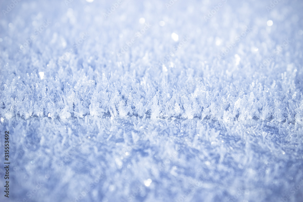 Texture of snow-white snowflakes on the surface. Freshly fallen snow with a beautiful texture. Beautiful frosty snow pattern in macro. Winter Wallpaper with frosty snowflakes. Texture of snow-white snowflakes on the surface. Freshly fallen snow with a beautiful texture. Beautiful frosty snow pattern in macro. Winter Wallpaper with frosty snowflakes.