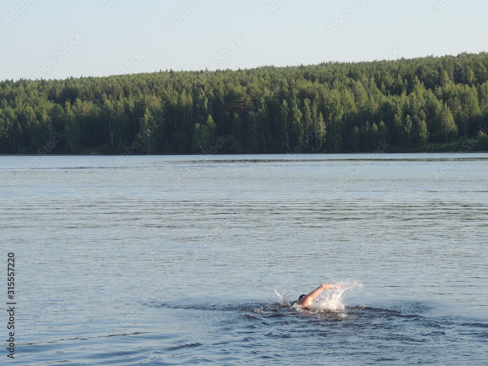 Fototapeta premium man swimming in the river
