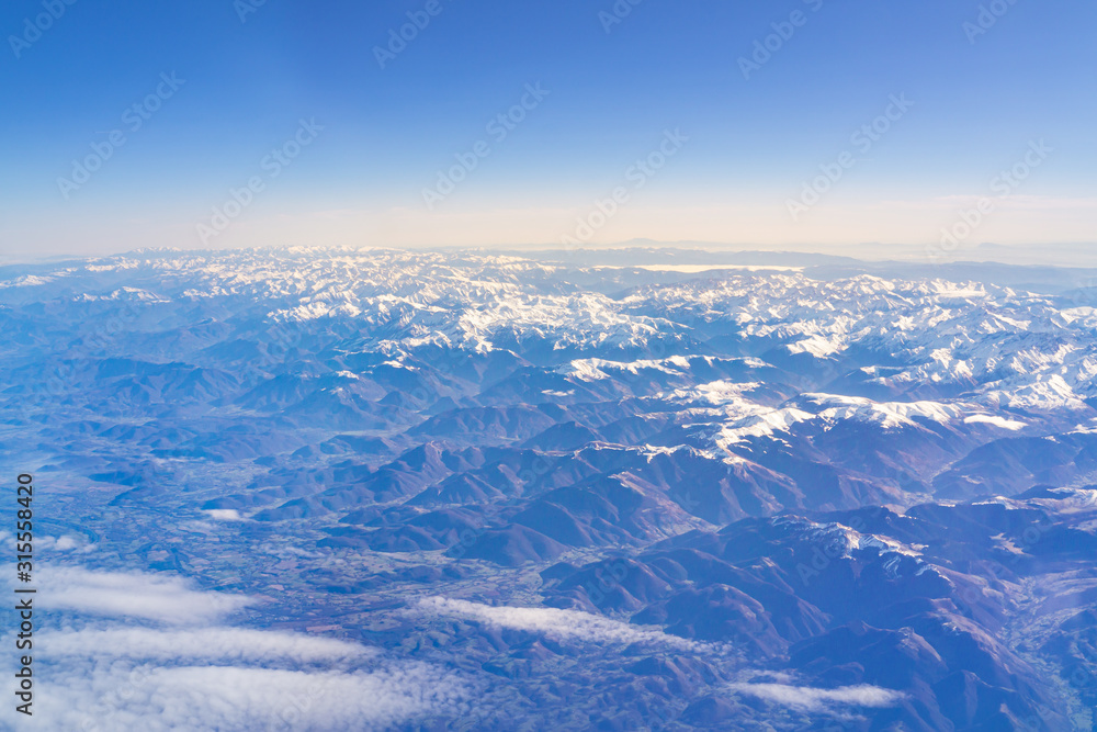 Fototapeta premium Flight over the snow capped mountains of the Pyrenees