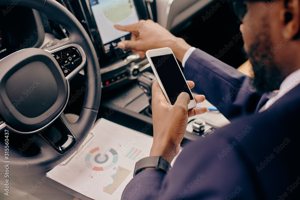 Close up of a man sitting in the car and scrolling through the phone feed. Close up of a man sitting in the car and scrolling through the phone feed.