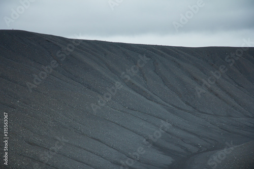 Iceland. Hverfell volcano. Black rocky soil in crater.