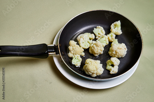 Cooking. Broccoli on a pan on a light background