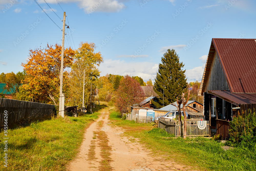 Village street with wooden house in summer day. Traditional old house in Russia Village street with wooden house in summer day. Traditional old house in Russia
