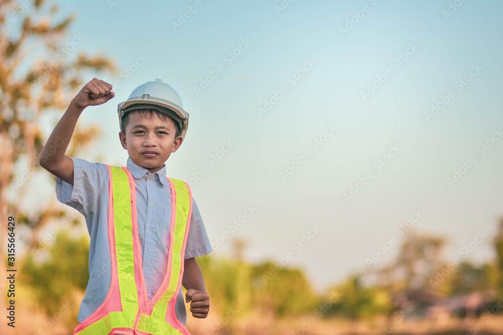 Boy kid Engineer standing outdoor holding hand success concept