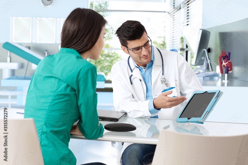 Doctor consulting with female patient Doctor consulting with female patient