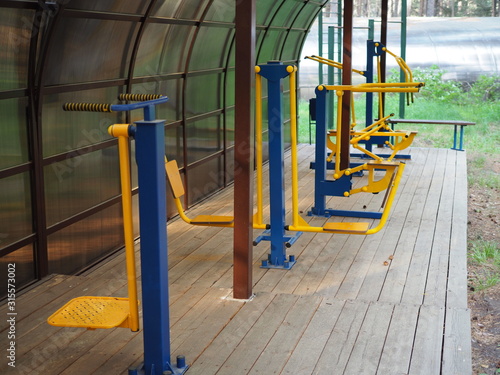 Colorful outdoor fitness equipment in summer under the shed