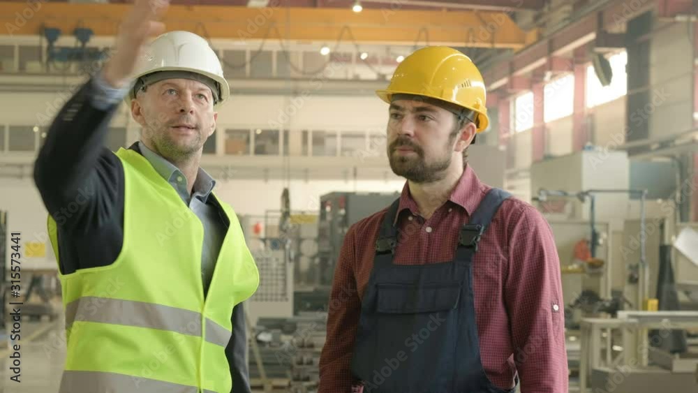 Employee and boss at factory meeting Employee and boss at factory meeting