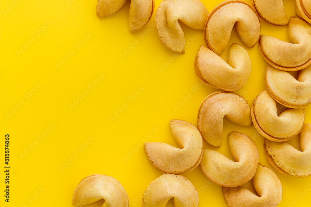 Fortune cookie frame on yellow background top-down copy space Fortune cookie frame on yellow background top-down copy space
