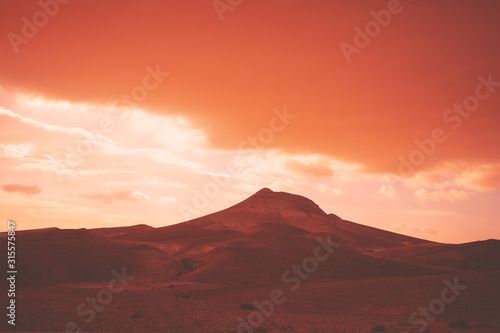 Mountainous desert with dramatic evening cloudy sky at sunset. The Judean Desert in Israel