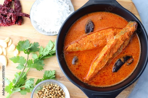 Goa Food - Indian Traditional Goan Pomfret or butter fish curry. Hot and spicy homemade fish gravy cooked using coconut milk and Indian spices. ingredients background with copy space.