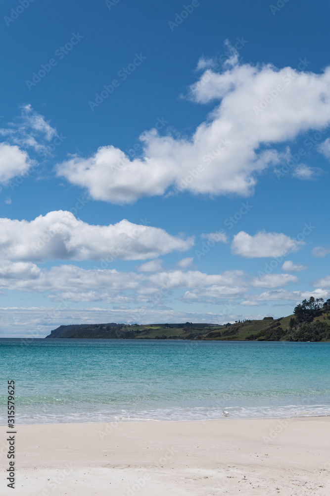 white clouds over beach in Tasmania