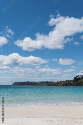 white clouds over beach in Tasmania