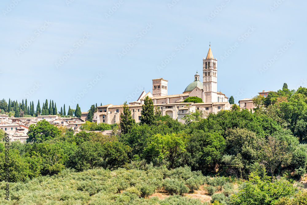 Town village city of Assisi in Umbria, Italy cityscape of church bell tower during sunny summer day in Etruscan countryside