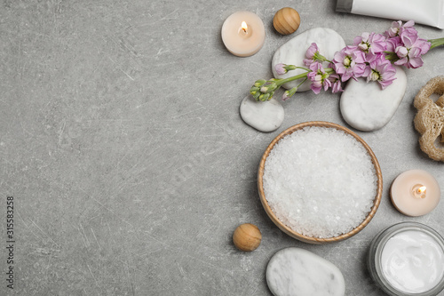 Flat lay composition with cosmetics on grey marble table  space for text. Spa treatment