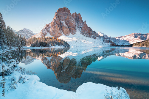 Fototapeta Naklejka Na Ścianę i Meble -  First snow Morning at Lake in Mount Assiniboine Provincial Park Canada Snow-covered winter mountain lake in a winter atmosphere. Nature in Rocky mountains. Beautiful background photo concept.