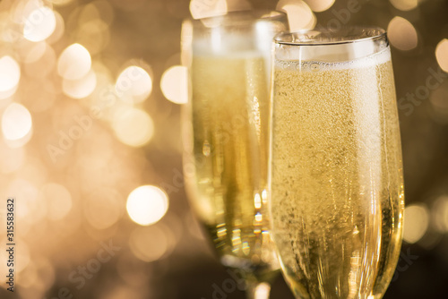 Closeup of champagne glass on a bokeh light background