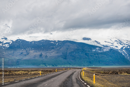 Iceland mountains view from ring road trip highway and snowcapped mountain cliff on cloudy day near Hof and Skaftafell national park