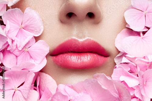 Close up view of beautiful woman lips with pink lipstick photo