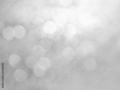 Abstract bokeh white background.Silver glittering christmas lights.
