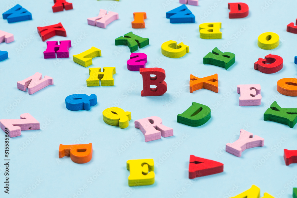 Multicolored letters on a blue background. Multicolored letters on a blue background.
