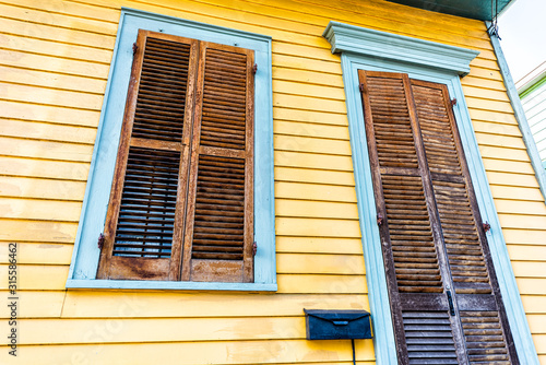New Orleans  USA old town street in Louisiana town city with blue yellow pastel colorful buildings doors window shutters home apartment row wall
