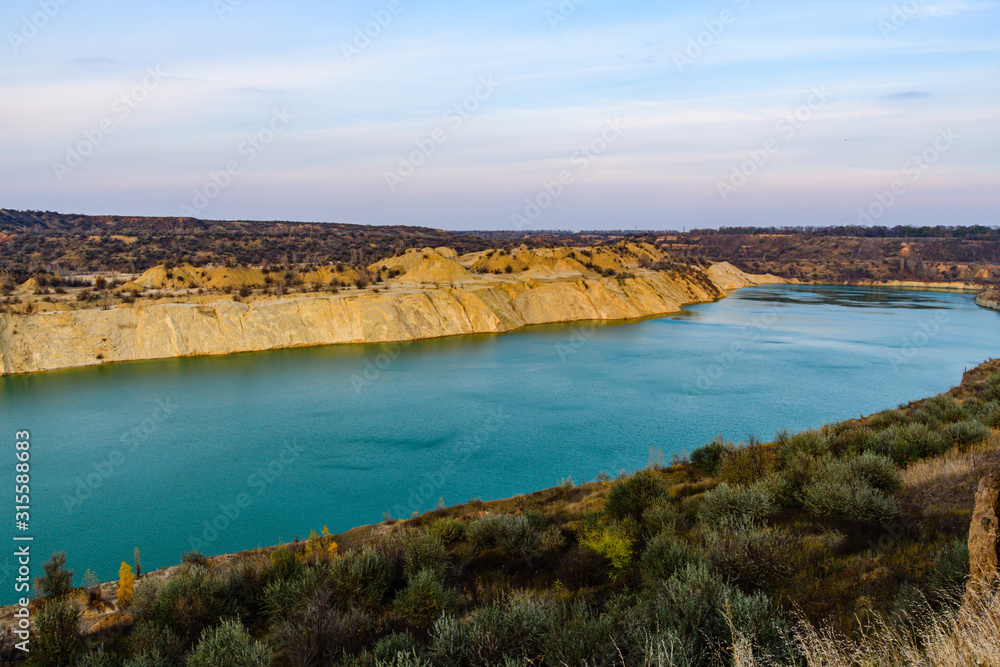 Lake with sandy bank in the abandoned coal quarry Lake with sandy bank in the abandoned coal quarry
