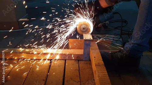 Welder at work with circular blade.