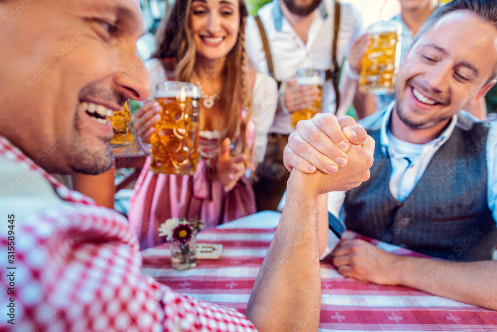 Bavarian friends practicing the high art of arm wrestling Bavarian friends practicing the high art of arm wrestling