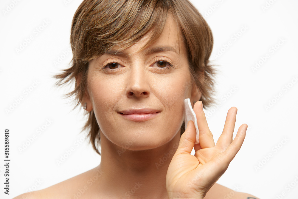 Beautiful woman with cotton pad, wiping off make up Beautiful woman with cotton pad, wiping off make up