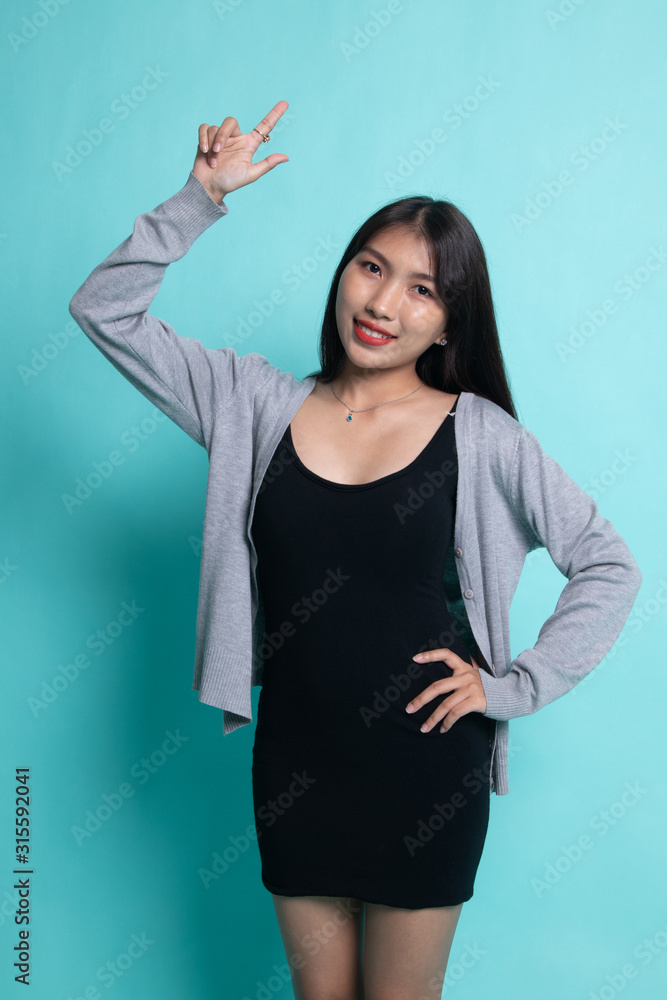 Fototapeta premium Young Asian woman smile and point up.