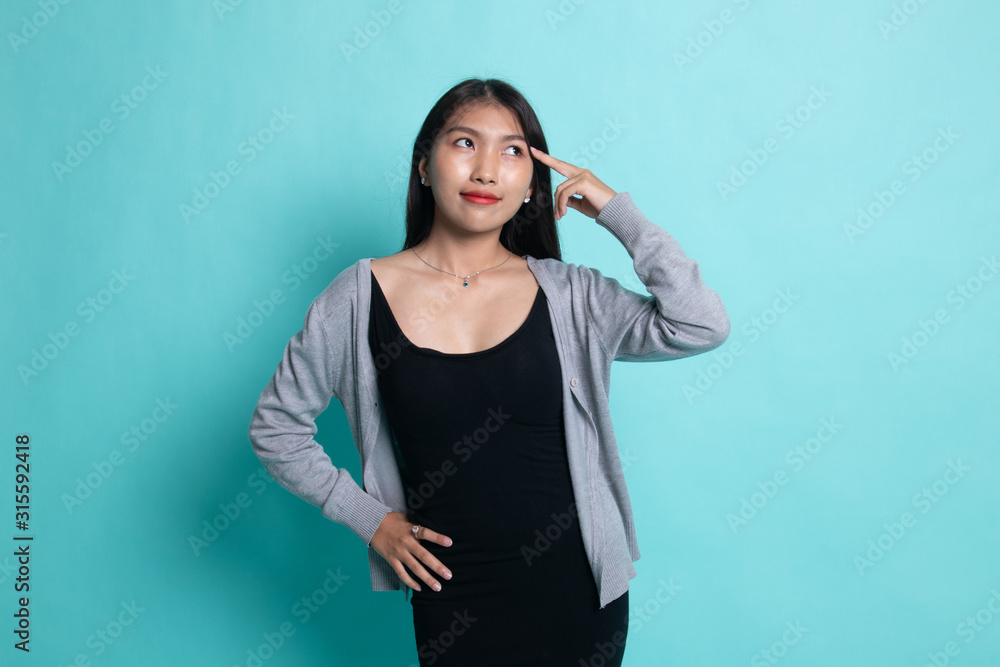 Beautiful young Asian woman holding fingers in gun gesture. Beautiful young Asian woman holding fingers in gun gesture.