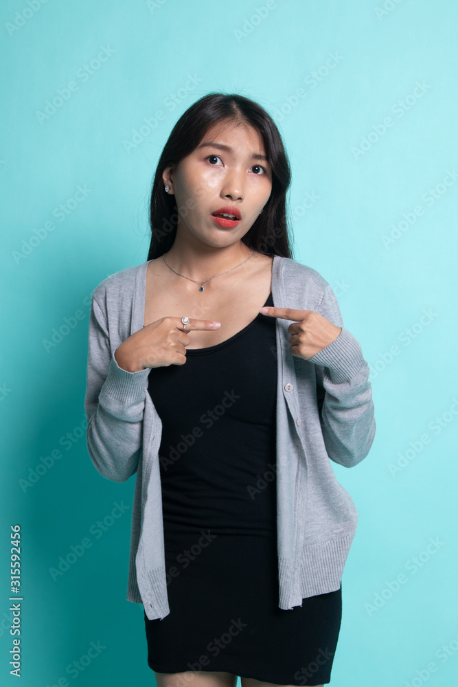 Young Asian woman point at herself ask why me. Young Asian woman point at herself ask why me.