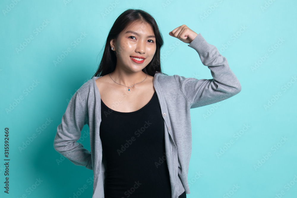Beautiful young Asian woman flex bicep. Beautiful young Asian woman flex bicep.