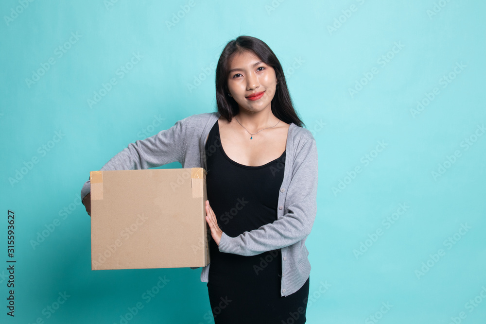 Delivery, relocation and unpacking. young asian woman holding cardboard box. Delivery, relocation and unpacking. young asian woman holding cardboard box.