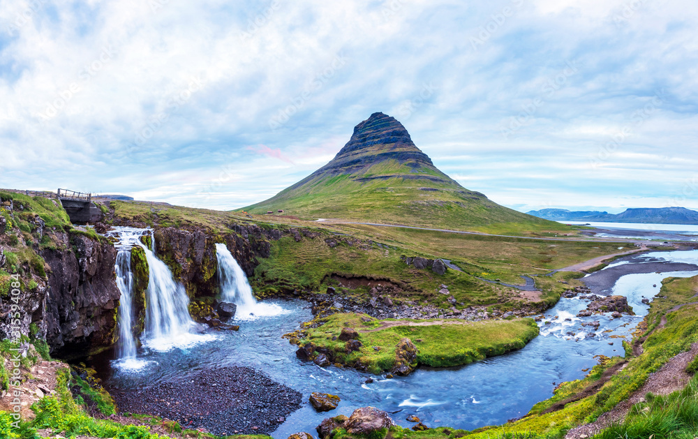 Beautiful natural magical scenery with a waterfall Kirkjufell near the volcano in Iceland. Exotic countries. Amazing places. Popular tourist atraction. (Meditation, antistress - concept).