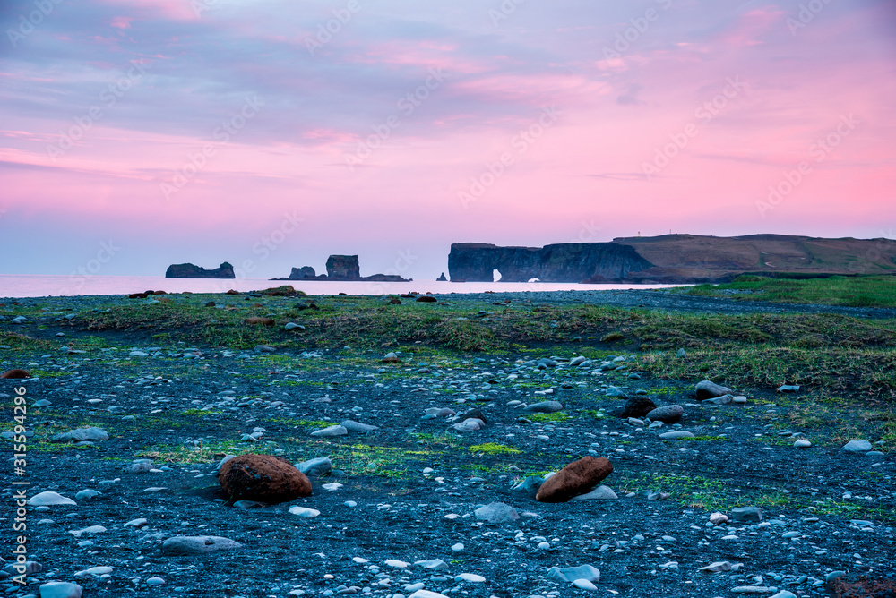 majestic view from the black sand beach on Reynisdrangar Sea Cliffs at dawn on cape Dyrholaey near Vik, Iceland. Exotic countries. Amazing places.