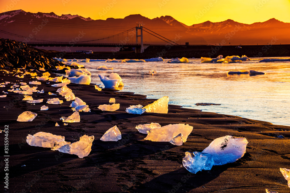 magical charming beautiful landscape with a piece of ice like a sculpture on the Diamond beach near glacier lagoon Jokulsarlon, Iceland. Exotic countries. Amazing places.