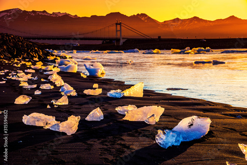 Obraz na płótnie magical charming beautiful landscape with a piece of ice like a sculpture on the Diamond beach near glacier lagoon Jokulsarlon, Iceland. Exotic countries. Amazing places. w salonie