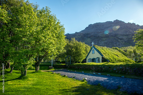 Obraz na płótnie Charming mystical scene with turf roof church in old Iceland traditional style and mystical cemetery in Hof, Skaftafell, Vatnajokull National Park. Exotic countries. w salonie