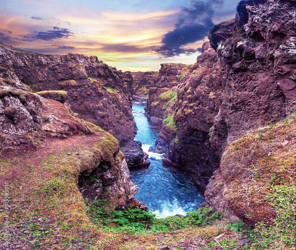 Beautiful magical landscape with a canyon Kolugljufur with water between the rocks in Iceland at sunrise. Exotic countries. Amazing places.
