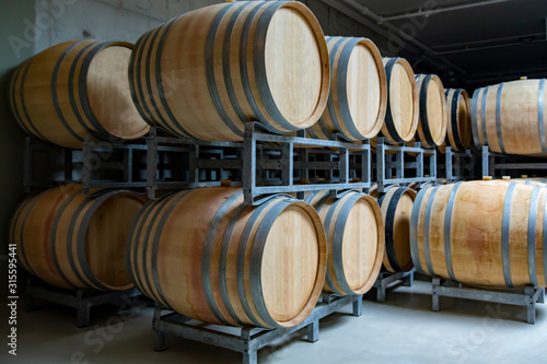 A view of a vineyard; vine barrels in cellar.