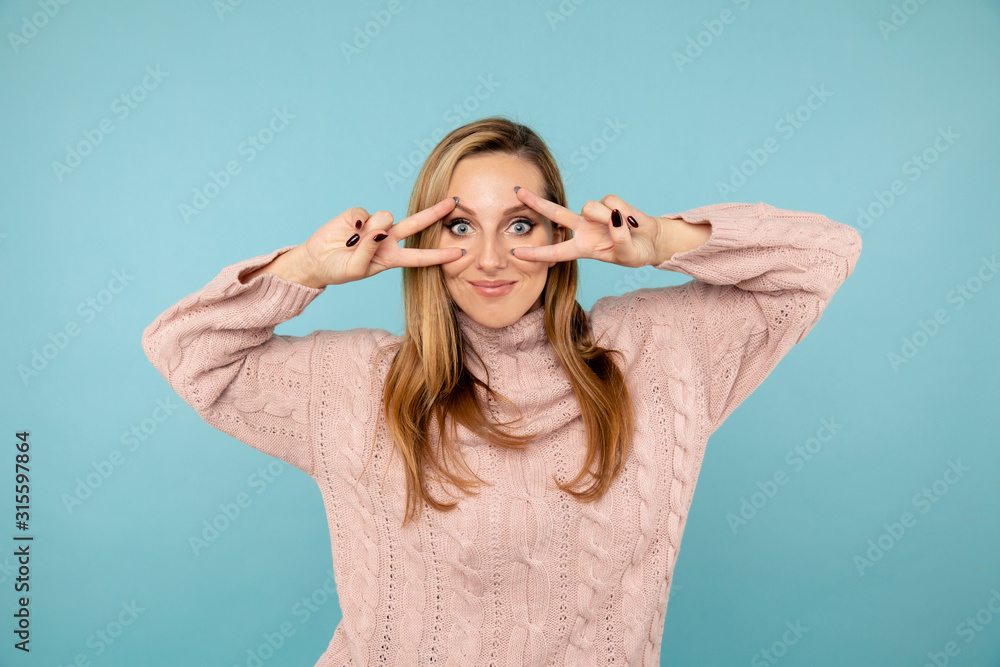 Portrait of pretty woman showing peace sign and kiss isolated in the studio Portrait of pretty woman showing peace sign and kiss isolated in the studio