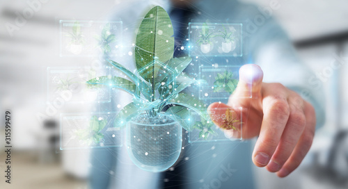 Man holding and touching holographic projection of a plant with digital analysis 3D rendering
