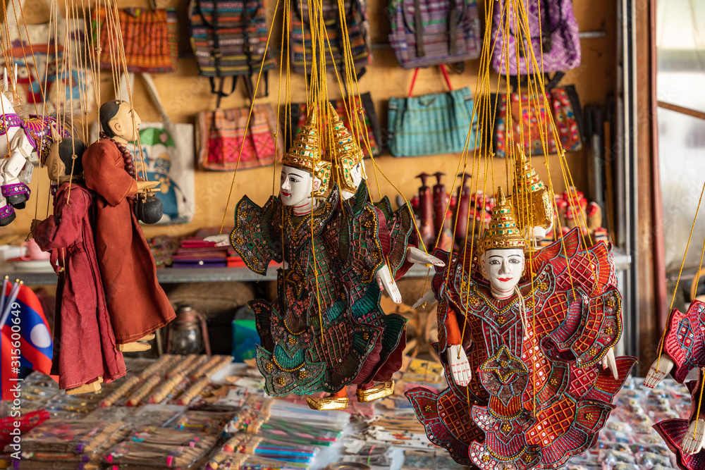 Traditional fabric decorative puppets for sale on the night market in Laos.