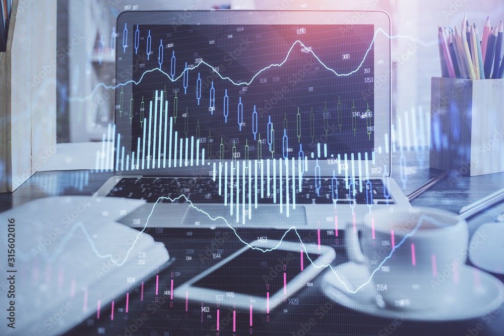 Financial chart drawing and table with computer on background. Double exposure. Concept of international markets. Financial chart drawing and table with computer on background. Double exposure. Concept of international markets.
