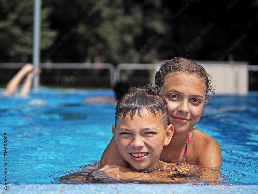 Fototapeta premium Little gir and boy in the swimming pool
