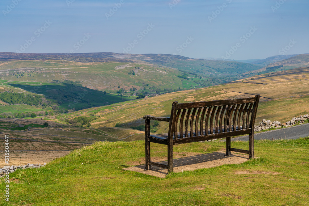 A bench with a view, seen at the Buttertubs Pass (Cliff Gate Rd) near Thwaite, North Yorkshire, England, UK A bench with a view, seen at the Buttertubs Pass (Cliff Gate Rd) near Thwaite, North Yorkshire, England, UK