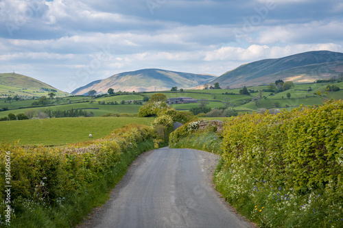 Rural road in the Yorkshire Dales landscape between Sedbergh and Beck Foot, Cumbria, England, UK photo