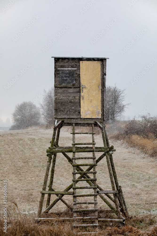 Wooden Hunters hunting tower in winter with snowfall, countryside landscape, Czech Republic, European Scenery Wooden Hunters hunting tower in winter with snowfall, countryside landscape, Czech Republic, European Scenery